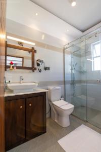 a bathroom with a toilet and a sink and a shower at Twin Villa Red - Cozy Colonial Villa with Mountain View in Nuwara Eliya