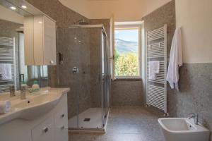 a bathroom with a sink and a shower with a window at Cascina Ca' Bark in Clusane sul Lago +45 photos
