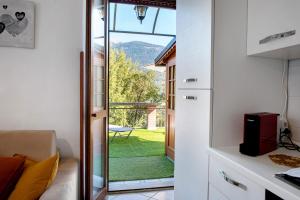 a kitchen with a sliding glass door leading to a yard at La Terrazza Panoramica in San Sebastiano