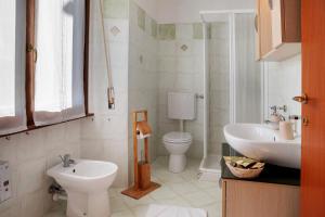 a bathroom with a toilet and a sink at La Terrazza Panoramica in San Sebastiano +23 photos