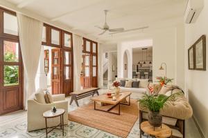 a living room with a couch and a table at La Morella - 4BHK Luxury Villa in Assagao with Private Pool, Garden, Balcony, Caretaker, Kitchen, Genset Backup, Security in Assagao +30 photos
