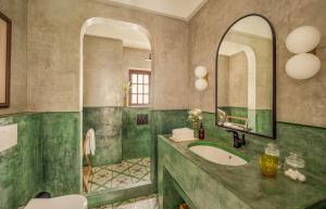 a bathroom with a sink and a mirror at La Morella - 4BHK Luxury Villa in Assagao with Private Pool, Garden, Balcony, Caretaker, Kitchen, Genset Backup, Security in Assagao