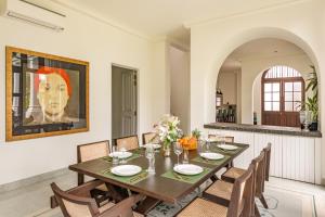 a dining room with a table and chairs at La Morella - 4BHK Luxury Villa in Assagao with Private Pool, Garden, Balcony, Caretaker, Kitchen, Genset Backup, Security in Assagao