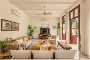 a living room with a couch and a table at La Morella by The Blue Kite - Elegant 4BHK Villa in Assagao with Private Pool, Garden, Caretaker in Assagao