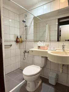 a bathroom with a toilet and a sink at Da Fu Di B&B in Jincheng +27 photos