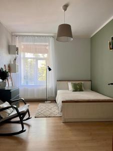 a bedroom with a bed and a window at Nice&cozy flat No7 in Rīga