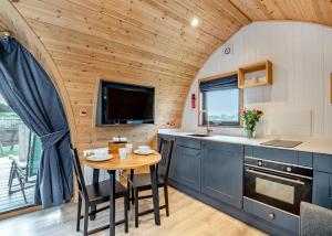 a kitchen with a table in a tiny house at South View Retreat in Carlton
