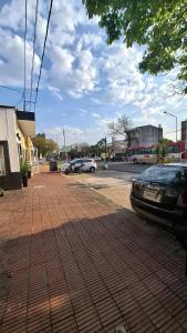 a brick parking lot with cars parked in a parking lot at Hospedaje Artigas in Corrientes