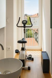 a bathroom with a exercise bike next to a sink at Suite Enes Terrazza con vista e relax in centro città in Trieste