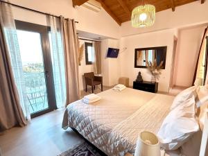 a bedroom with a bed and a large window at Delight House's in Afitos