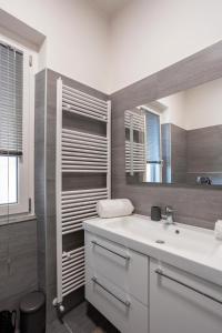 a bathroom with a white sink and a mirror at Rocca Lake House in Angera +27 photos