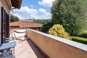 a balcony with a bench and a view of a house at Rocca Lake House in Angera