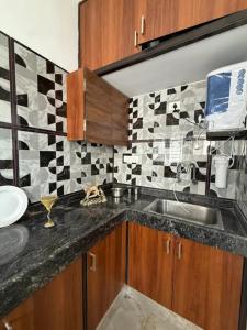 a kitchen with a sink and a counter top at The Cozy Cranny in Chennai