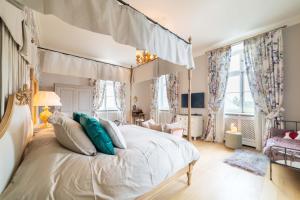 a bedroom with a canopy bed with blue pillows at Château de Berg in Berg-sur-Moselle +61 photos