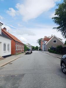 a street with cars parked on the side of the road at Charming 2 bedroom apartment free parking in Hjørring