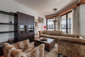 a living room with couches and a table at Yamina Luxury Apartment by Quokka 360 - Next to Lido di Lugano in Lugano +32 photos