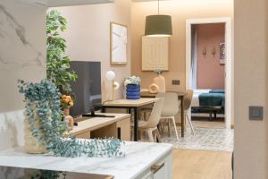 a living room and dining room with a table and chairs at Sagrada Familia Xamfrà in Barcelona