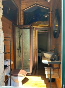 a bathroom with a toilet and a sink at Casa Arxemil in Sarria