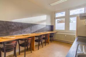 a kitchen with a row of tables and chairs at Reform in Magdeburg