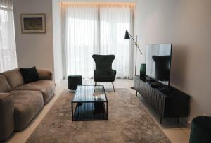 a living room with a couch and a coffee table at 360 Luxury One Bedroom Suite in Nicosia