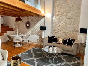 a living room with a couch and a table at Oporto Golden Apartment in Porto