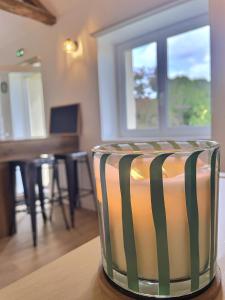 a striped chair sitting on top of a table at Domaine Jubare in Fuissé +12 photos