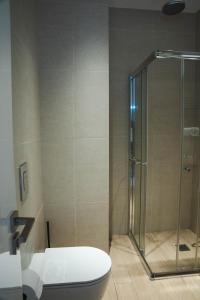 a bathroom with a toilet and a glass shower at 360 Luxury One Bedroom Suite in Nicosia +5 photos