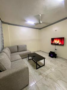 a living room with a couch and a fireplace at Bamburi Getaway Studio in Mombasa +28 photos