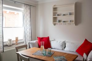 a living room with a table and a couch at Hotel & Ferienunterkünfte Hus Seeblick in Fehmarn
