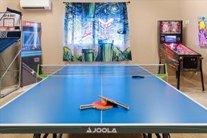 a ping pong table in a room with arcade games at Mountain Views - Pool - Games - YogaDeck in Carefree