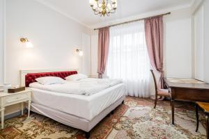 a bedroom with a bed and a desk and a piano at Househost Apt: Starowiślna 75/3/1 in Krakow +4 photos