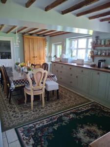 a kitchen with a table and chairs in a kitchen at Newby Cross in Carlisle