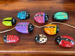 a group of colorful stones on a wooden table at Σπιτάκι στον κήπο in Rafina
