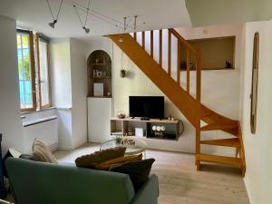 a living room with a couch and a staircase at Besançon: charmant duplex au pied de la citadelle in Besançon