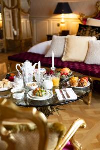 a coffee table with food on it in a living room at Château de Berg in Berg-sur-Moselle