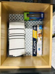 un cassetto con asciugamani e altri articoli di Cozy 2 Bedroom Suite Pet Friendly Garage a Edmonton