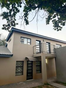 a house with a balcony on top of it at Country Farm House in Delmas