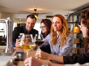 a group of people sitting at a table with wine glasses at Mercure Lyon Centre Plaza République in Lyon +106 photos