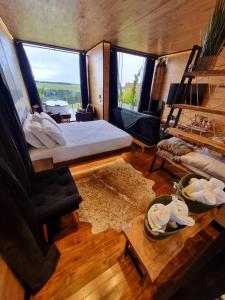 a room with a bed and a couch and a table at Parador dos Canyons in Cambará +14 photos