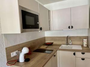 a kitchen with a sink and a microwave at Studio cosy avec balcon, 4 couchages à Vars, proche pistes et commerces - FR-1-330B-211 in Vars +5 photos