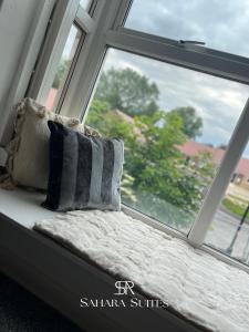 a window seat with two pillows in front of it at Modern 2BR Flat - Sleeps 4 - Newcastle City & St James - Parking in Elswick