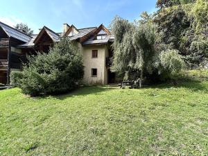 une maison avec un arbre dans la cour dans l'établissement Charmant T2 cabine avec jardin et parking près de Serre Chevalier - FR-1-330F-243, au Monêtier-les-Bains 15 autres photos