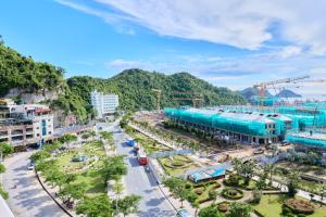 an aerial view of a city with mountains in the background at Phoenix Flower Hotel & Travel in Cat Ba