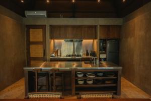 a kitchen with a large island in the middle at Mémé Villa Siargao in General Luna