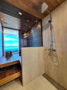 a bathroom with a shower and a window at Marina Resort A8 in Kalajoki +22 photos