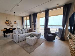 a living room with a couch and a table at Marina Resort A8 in Kalajoki