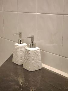 two white toothbrushes sitting on a counter in a bathroom at Tranquil & Elegant Stay Near Parliament in Talangama South