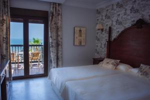 Postel nebo postele na pokoji v ubytování Hotel Playa de Regla
