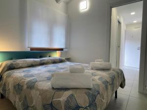 a bedroom with a bed with towels on it at CASE VACANZE 24 - Somma Lombardo in Somma Lombardo