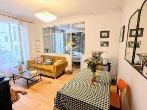 パリにあるSuperbe appartement, tout confort 2 personnesのソファとテーブルのあるリビングルーム
